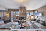 Experience luxury living in this stunning chalet, featuring a cozy fireplace and a spacious living area.
