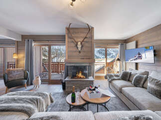 Experience luxury living in this stunning chalet, featuring a cozy fireplace and a spacious living area.