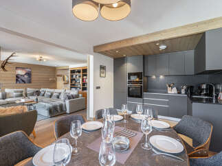 Experience luxury living in this stunning property, featuring a modern kitchen with sleek cabinetry and high-end appliances.