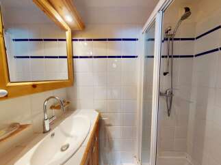 This charming bathroom features a bright and airy design, perfect for starting your day.
