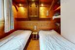 Cozy cabin bedroom featuring two twin beds, perfect for a comfortable stay.