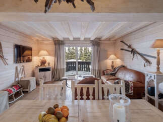 Experience rustic charm in this cozy mountain retreat, featuring exposed wooden beams and a warm, inviting living space.