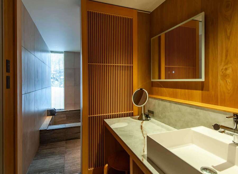 Step into luxury with this stunning bathroom featuring exquisite wooden accents and a modern design.