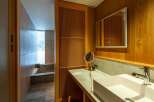 Step into luxury with this stunning bathroom featuring exquisite wooden accents and a modern design.