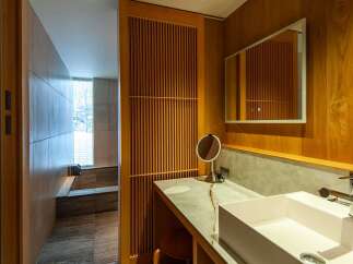 Step into luxury with this stunning bathroom featuring exquisite wooden accents and a modern design.