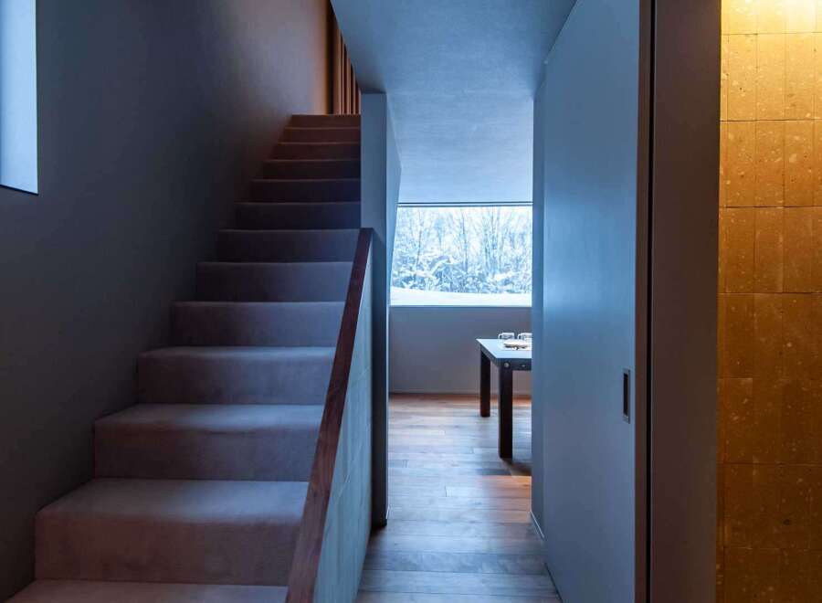 This stunning property features a modern staircase leading to the upper levels.