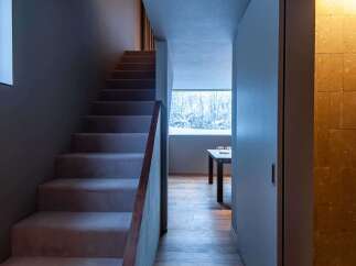 This stunning property features a modern staircase leading to the upper levels.