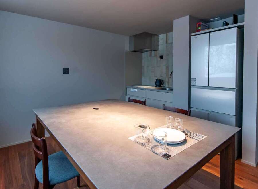 This modern dining area features a sleek, minimalist design, perfect for contemporary living.