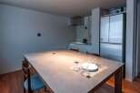 This modern dining area features a sleek, minimalist design, perfect for contemporary living.