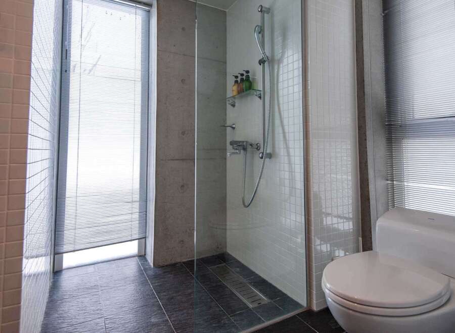 Step into a modern bathroom oasis! This stunning space features a sleek glass-enclosed shower, perfect for a refreshing start to your day.