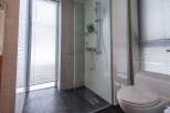 Step into a modern bathroom oasis! This stunning space features a sleek glass-enclosed shower, perfect for a refreshing start to your day.