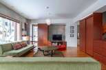 This modern living space boasts a sleek design with concrete walls and warm wooden accents.