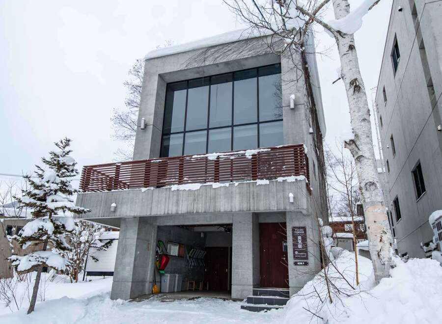 This modern concrete building offers a unique architectural design with a spacious interior and large windows.