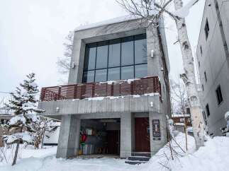 This modern concrete building offers a unique architectural design with a spacious interior and large windows.