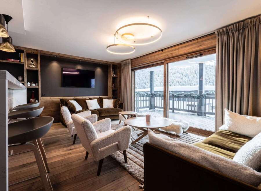 Experience luxury living in this stunning property, featuring a cozy living room with a fireplace and a modern kitchen.