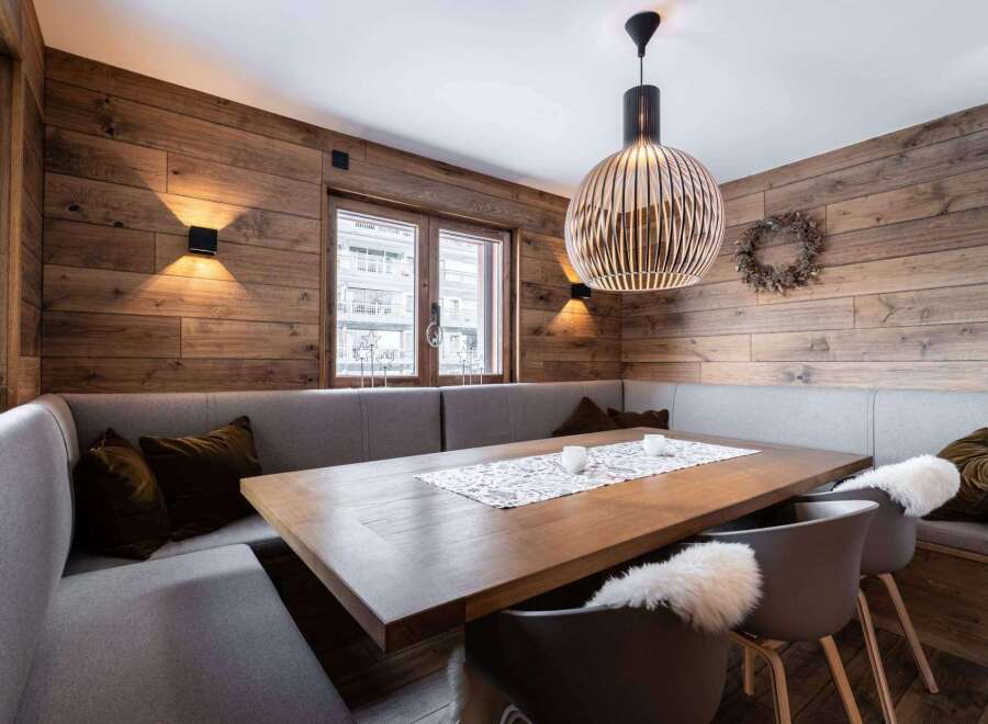Experience the warmth of this inviting dining space, featuring stunning wood paneling that adds a touch of rustic elegance.