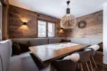 Experience the warmth of this inviting dining space, featuring stunning wood paneling that adds a touch of rustic elegance.