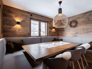 Experience the warmth of this inviting dining space, featuring stunning wood paneling that adds a touch of rustic elegance.