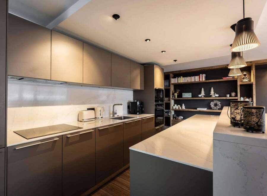 This modern kitchen boasts sleek cabinetry and a spacious island, perfect for culinary enthusiasts.