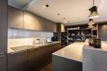 This modern kitchen boasts sleek cabinetry and a spacious island, perfect for culinary enthusiasts.