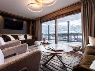 Experience luxury living in this stunning property, featuring a cozy living room with plush seating and a modern fireplace.