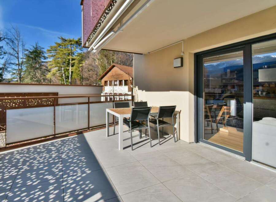 Enjoy breathtaking views from this stunning balcony! This property features a modern outdoor dining set, perfect for entertaining or relaxing.