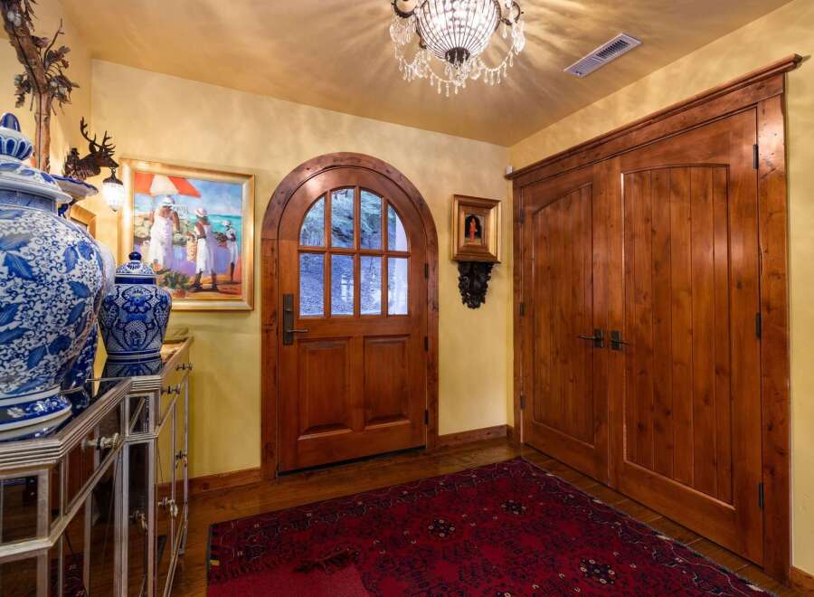 Step into luxury with this stunning entryway, showcasing exquisite craftsmanship and timeless elegance.
