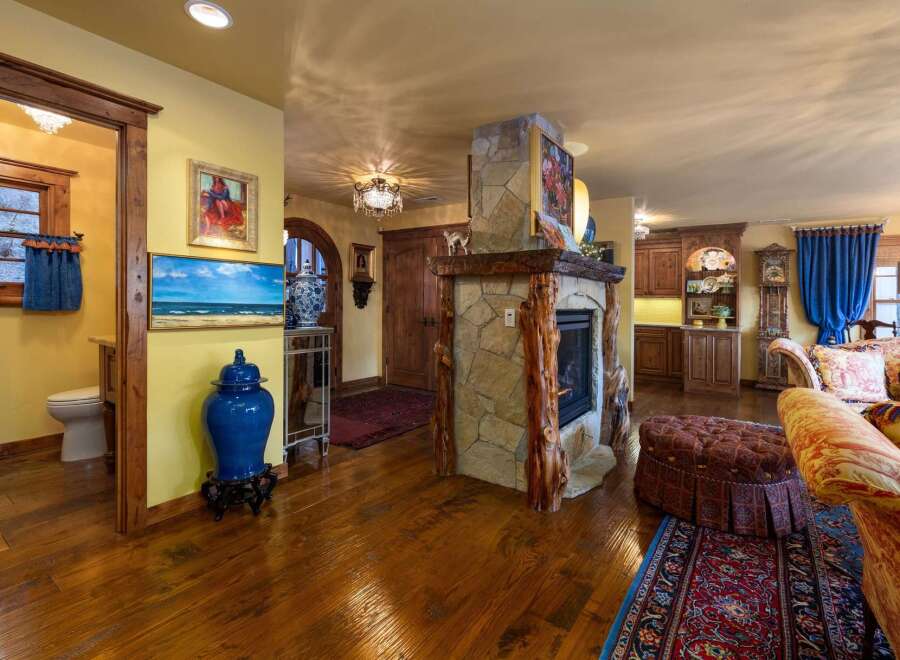 Step into luxury with this stunning property, featuring a cozy fireplace and exquisite hardwood floors.