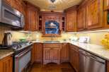 Step into a beautifully designed kitchen featuring custom wooden cabinetry and elegant granite countertops.