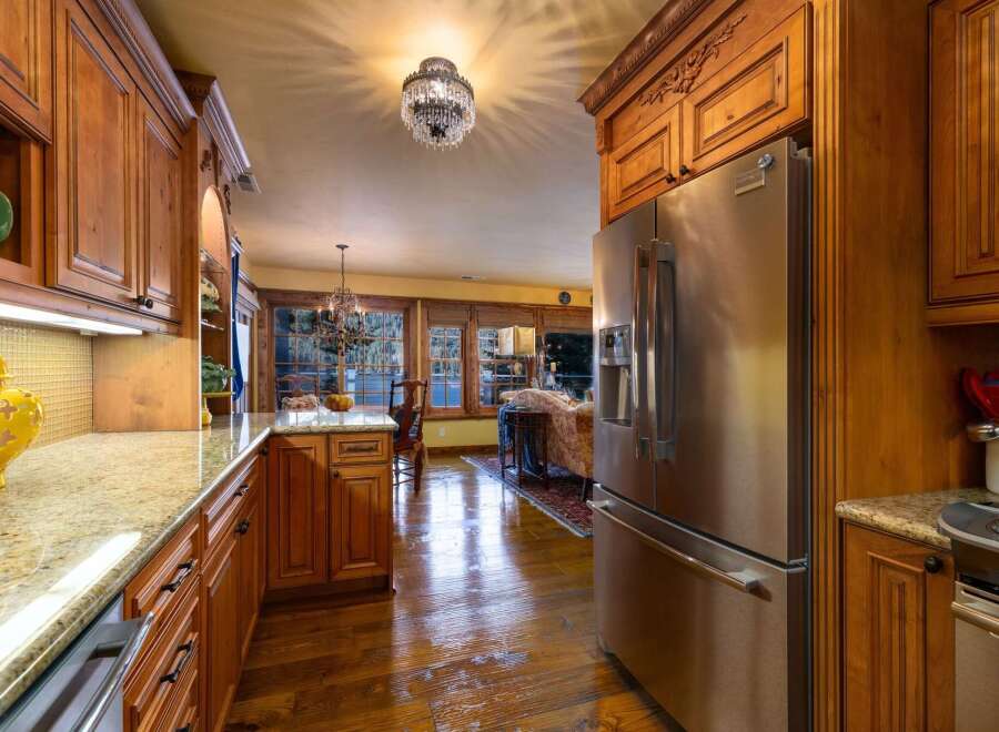 Step into luxury with this stunning kitchen! Featuring custom wood cabinetry, granite countertops, and stainless steel appliances, this space is perfect for both cooking and entertaining.