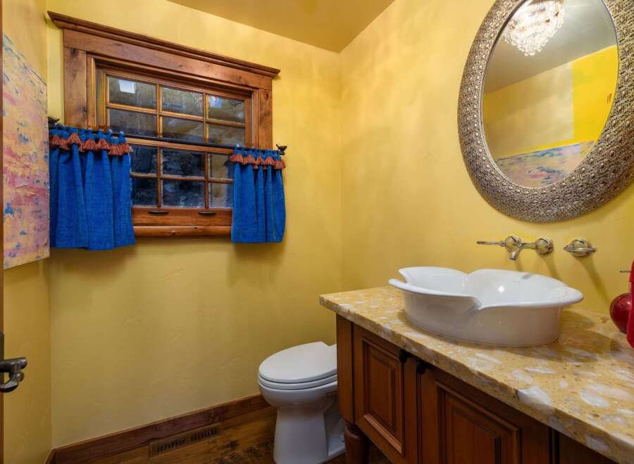 This charming bathroom boasts a unique blend of rustic and elegant design elements.