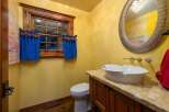 This charming bathroom boasts a unique blend of rustic and elegant design elements.
