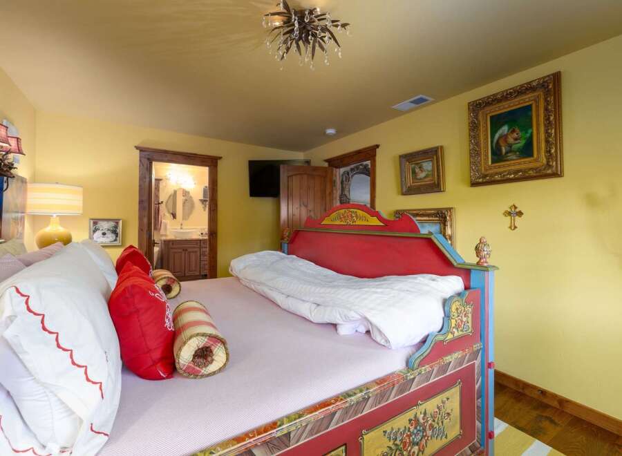 Step into a whimsical bedroom retreat! This charming space features a uniquely designed bed with vibrant colors and intricate details.