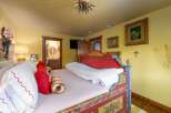 Step into a whimsical bedroom retreat! This charming space features a uniquely designed bed with vibrant colors and intricate details.