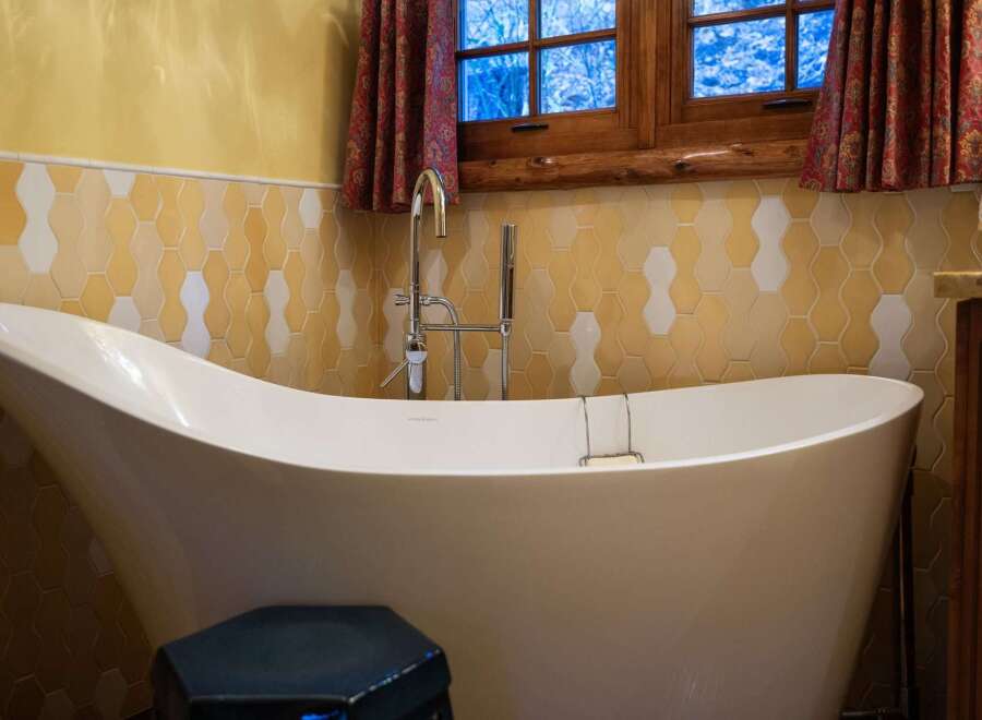 Indulge in the luxury of this stunning bathroom, featuring a modern freestanding bathtub.