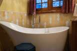 Indulge in the luxury of this stunning bathroom, featuring a modern freestanding bathtub.