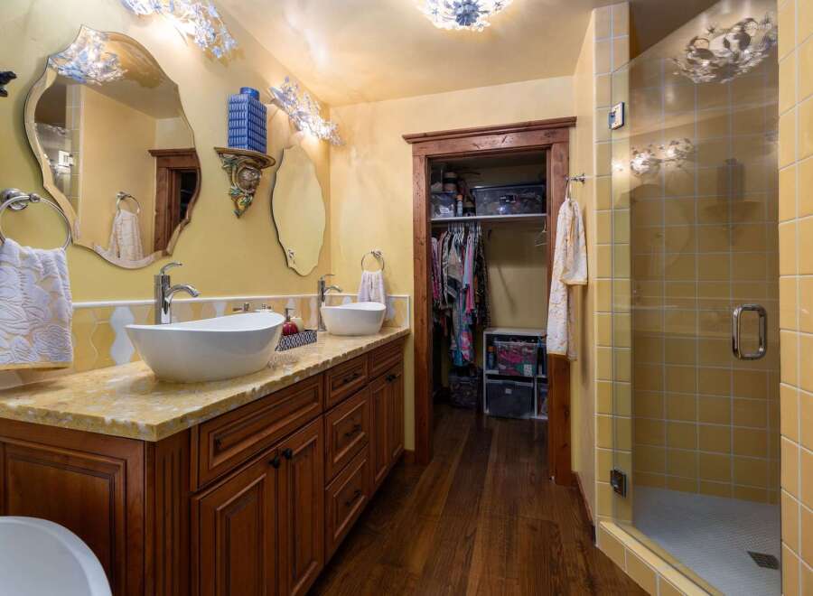 Step into luxury with this stunning bathroom featuring a double vanity with vessel sinks and a beautiful countertop.