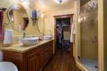 Step into luxury with this stunning bathroom featuring a double vanity with vessel sinks and a beautiful countertop.