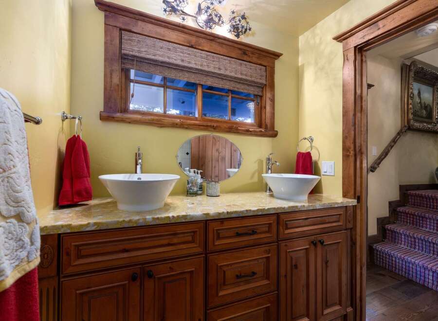 This stunning bathroom boasts a luxurious design with a double vanity and elegant fixtures.