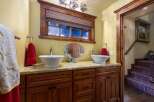 This stunning bathroom boasts a luxurious design with a double vanity and elegant fixtures.