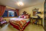This charming bedroom offers a cozy retreat with its warm color palette and inviting decor.