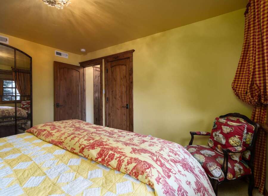 Step into this charming bedroom, featuring a blend of rustic and elegant design elements.