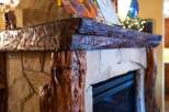 This stunning fireplace is a focal point in any home, featuring a unique wooden mantel that adds rustic charm.