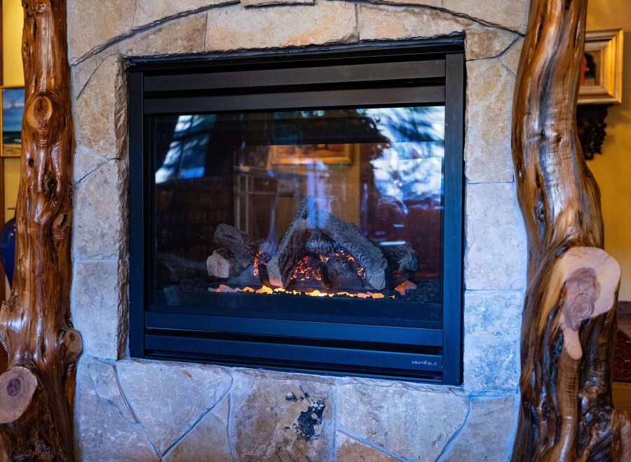 This stunning property features a cozy fireplace, perfect for those chilly evenings.