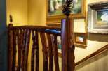 This stunning property boasts a unique rustic design, featuring a beautifully crafted wooden railing.