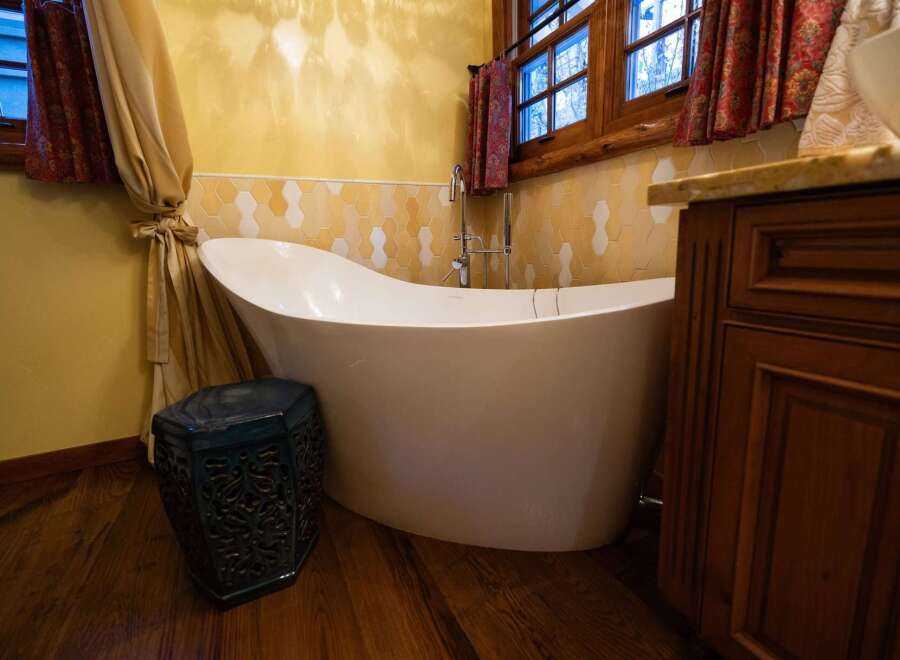 Indulge in luxury with this stunning bathroom featuring a modern freestanding tub.