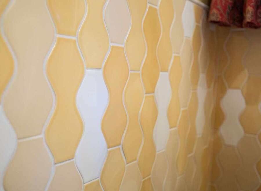 This property features a stunning tiled wall with a unique pattern.