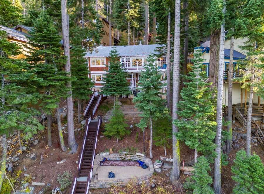 Nestled amidst towering trees, this stunning property offers a serene escape.
