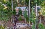 Nestled amidst towering trees, this stunning property offers a serene escape.