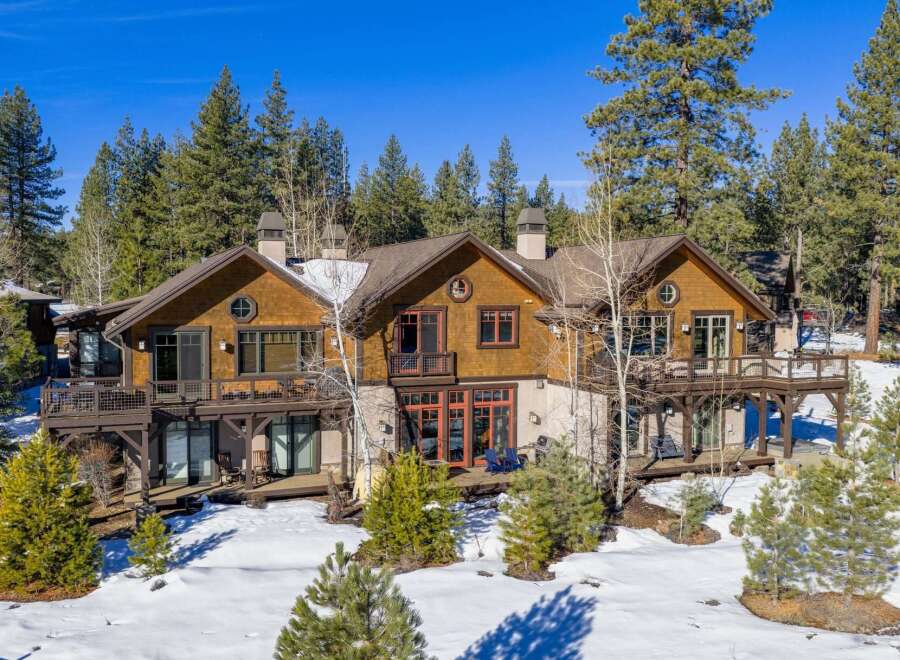 Nestled amidst a serene, snow-covered landscape, this stunning property boasts a blend of rustic charm and modern elegance.